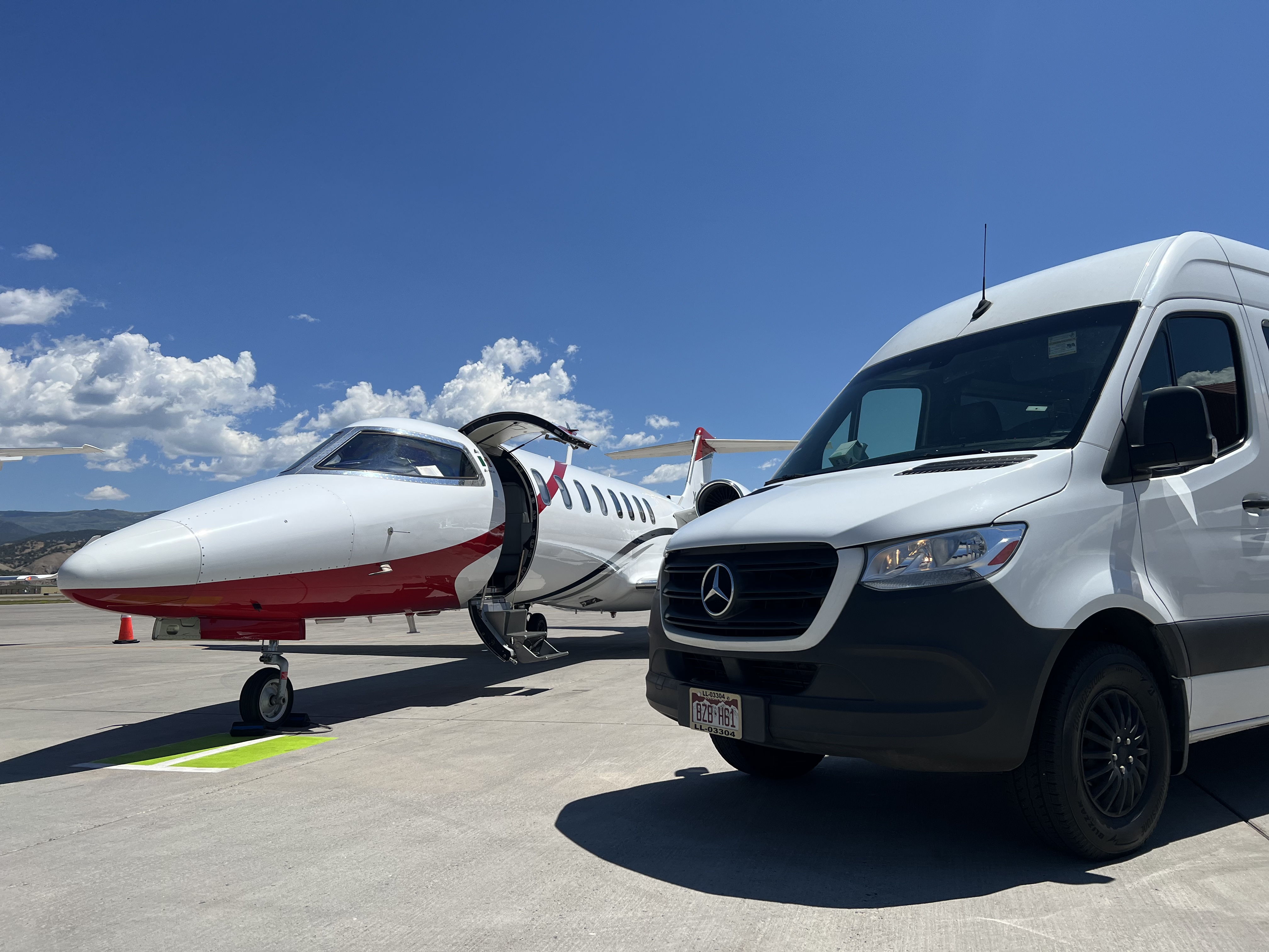 Denver Airport Limo Service with van near plane