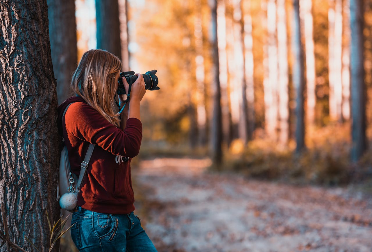 Girl in forest taking photos